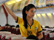 Stewardesses in Brazilian soccer jerseys