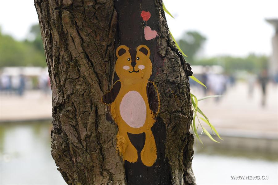 Fifteen art students of the university created 30 tree hollow paintings on campus to greet freshmen as new semester started.