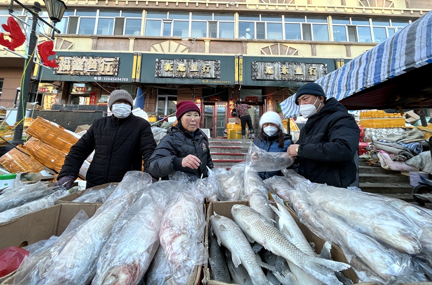 Colorfully lit snow sculptures, busy fish market add festive atmosphere in China's easternmost city