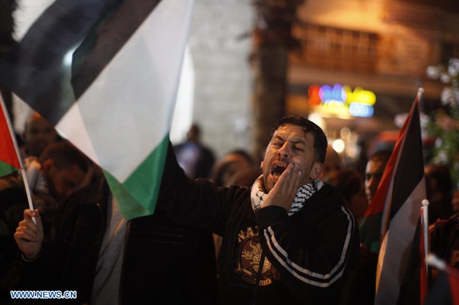 A Palestinian man takes part in a protest in the West Bank city of Ramallah against Israeli airstrikes on the Gaza Strip, Nov. 14, 2012. Several Palestinians were killed following a series of Israel's concurrent airstrikes on Gaza city, among them was Ahmed al-Jaabari, top commander of Hamas armed wing Al-Qassam brigades, and more than 40 others wounded, government's emergency services in the Gaza Strip said. (Xinhua/Fadi Arouri)