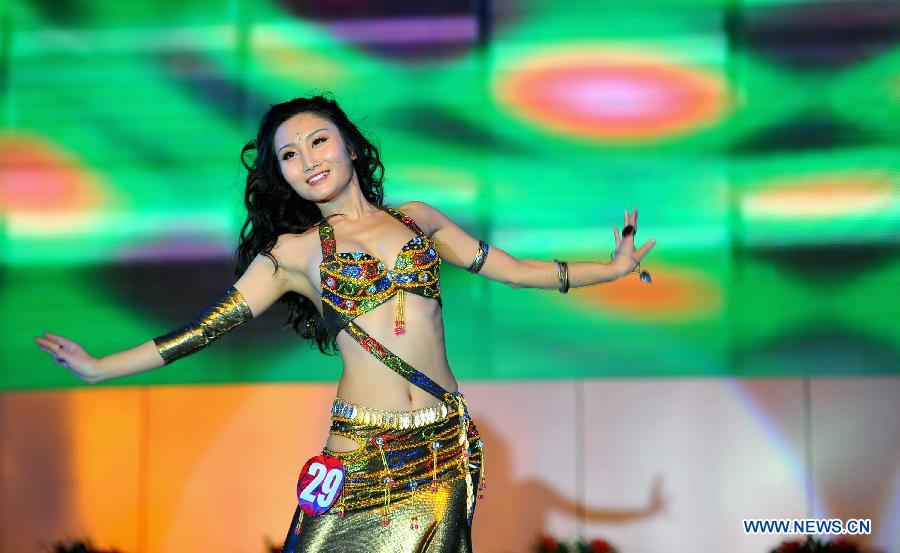 A mother-to-be performs at a mothers-to-be pageant in Taiyuan, capital of north China's Shanxi Province, Nov. 18, 2012. A total of 35 expectant mothers attended the pageant which was held on Sunday. (Xinhua/Yan Yan) 