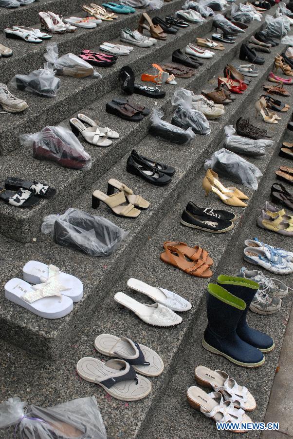 Hundreds of women's shoes cover the steps of Vancouver Art Gallery during annual Shoe Memorial in Vancouver, Canada, Dec. 6, 2012. December 6th is Canada's National Day of Mourning for women who have met with violent deaths. Shoes in bags represent dead women, and those without bags represent women who are alive but suffer from abuse. (Xinhua/Sergei Bachlakov)