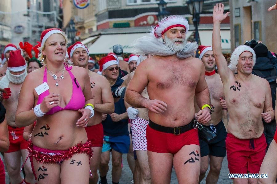 People take part in a half naked "Santa run" in Budapest, Hungary, Dec. 9, 2012. (Xinhua/Attila Volgyi) 