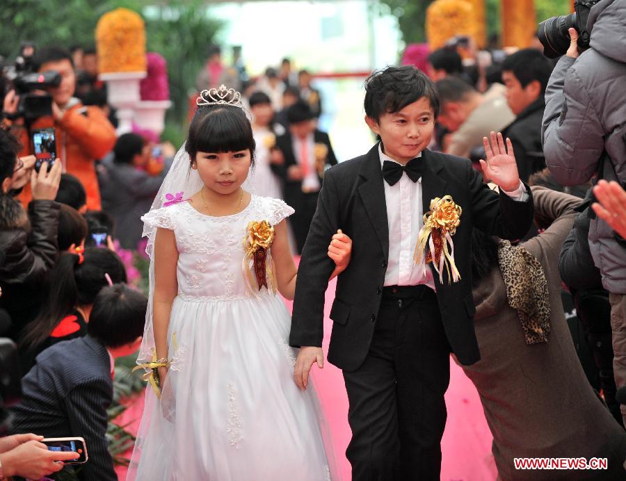 Seven couples who are about 126-centimeter-tall from a Beijing shadow play troupe attend a group wedding on Dec. 1, 2012. (Xinhua)