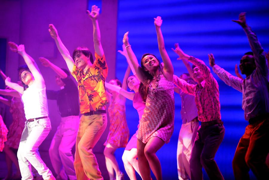 Actors and actresses perform in musical "Mamma Mia!" at the Gansu Grand Theater in Lanzhou, capital of northwest China's Gansu Province, Dec. 26, 2012. The Chinese version of classic musical "Mamma Mia!" was staged in Gansu with six performances starting from Dec. 25. Over 42 million people across the world have seen the musical since the original London production opened in 1999. (Xinhua/Zhang Meng) 