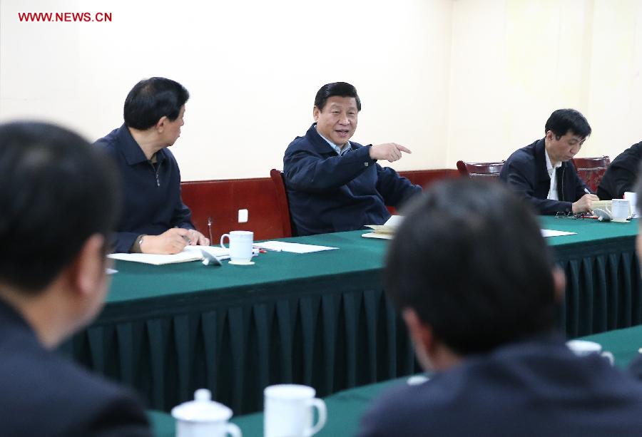 Xi Jinping (C), general secretary of the Communist Party of China (CPC) Central Committee and chairman of the CPC Central Military Commission, listens to reports by local authorities about poverty-alleviation work after his arrival in Fuping County, north China's Hebei Province, Dec. 29, 2012. Xi made a tour to impoverished villages in Fuping County from Dec. 29 to 30, 2012. (Xinhua/Lan Hongguang) 