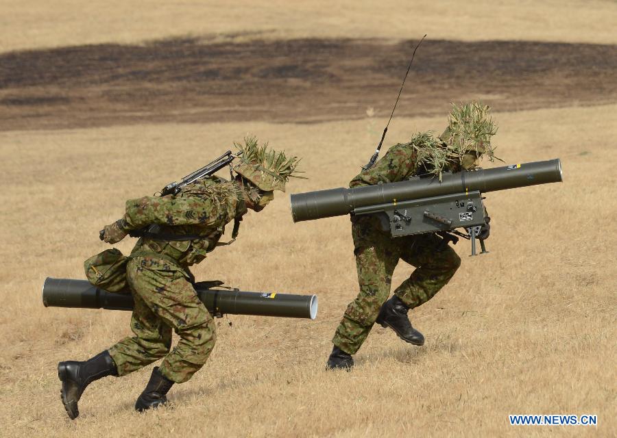 Members of Japan's Ground Self Defense Force 1st Airborne Brigade take part in a military exercise in Narashino, suburban Tokyo, Japan, Jan. 13, 2013. A total of 300 personnel, 20 aircraft and 33 vehicles took part in the open exercise at the defense force's Narashino training ground. (Xinhua/Ma Ping)