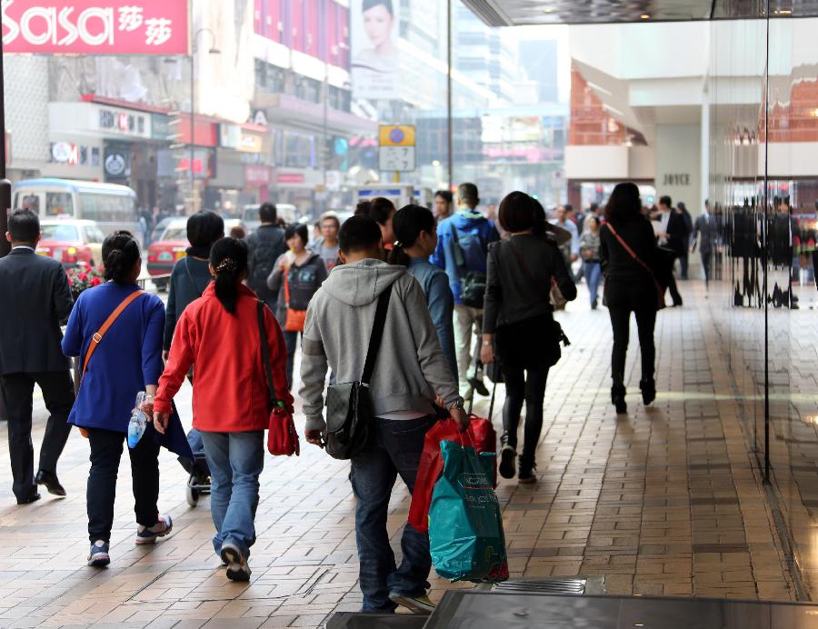 Customers are seen at the Canton Road business district of Tsim Sha Tsui in Hong Kong, south China, Jan. 24, 2013. As the Spring Festival coming, shops in Hong Kong started to offer discounts for increasing customers. (Xinhua/Li Peng) 