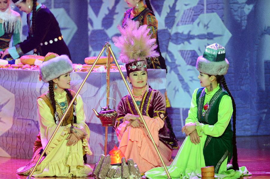 Actors perform in stage play Snowland Families in Altay, northwest China's Xinjiang Uygur Autonomous Region, Jan. 29, 2013. The stage play, created and performed by Altay Art Troupe, tells stories along the ancient Silk Road. (Xinhua/Sadat)