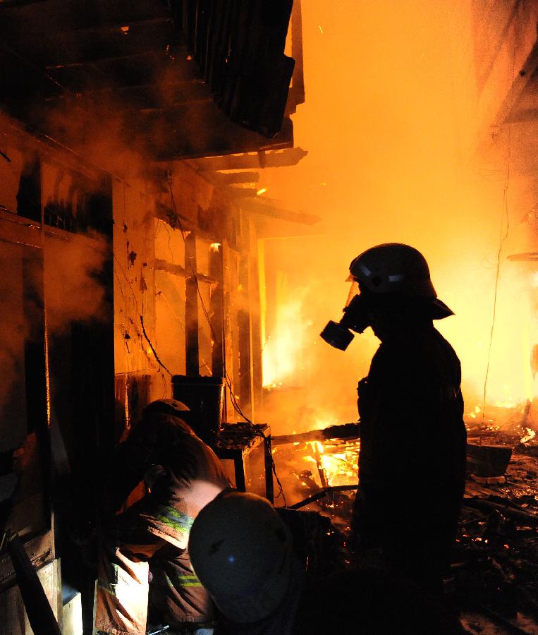 Firefighters try to extinguish the fire at Duri Selatan, Tambora, west Jakarta, Indonesia, Feb. 7, 2013. About 70 tenements were burnt in the fire, affecting 2,284 residents, according to Isnawa Adji, Head of the Subdistrict of Tambora. (Xinhua/Veri Sanovri) 