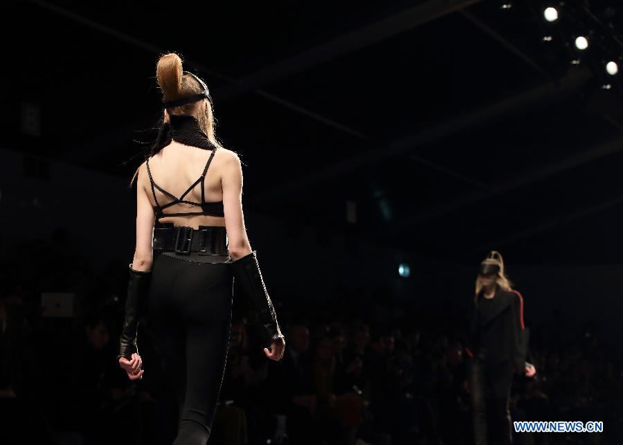 A model presents a creation by Chinese designer Haizhen Wang during London Fashion Week in London, Britain, on Feb. 19, 2013. (Xinhua/Yin Gang) 