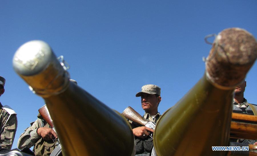 Afghan border police stand guard while Taliban's ammunition is presented to the media in Nangarhar province, eastern Afghanistan, on March 2, 2013. Afghan border police captured seven Taliban fighters with their ammunition during a operation in Nangarhar province on Saturday. (Xinhua/Tahir Safi) 