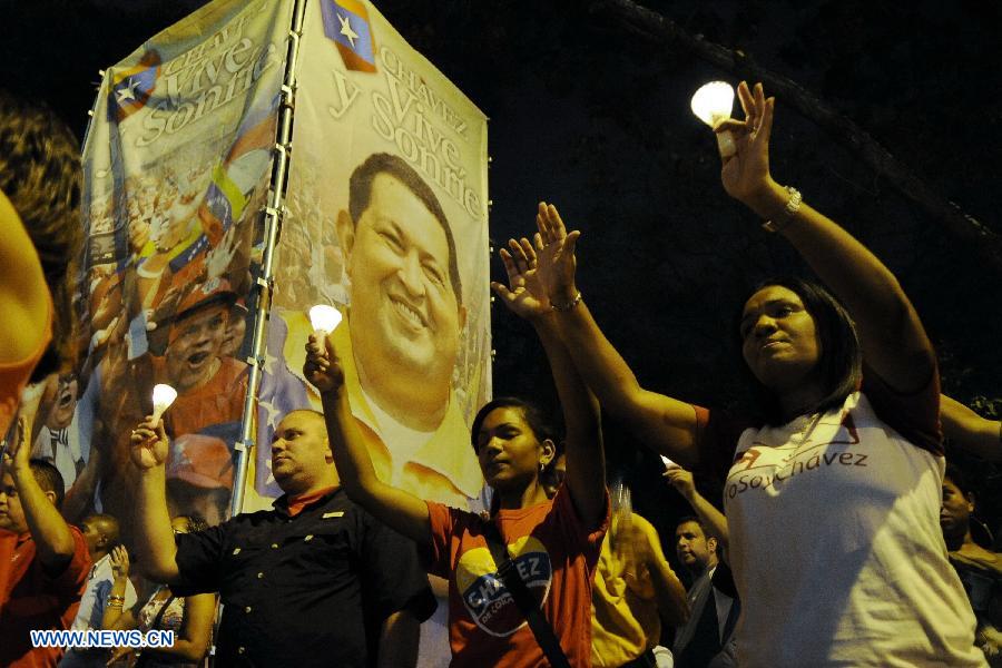 Residents participate in a vigil in support of Venezuelan President Hugo Chavez in front of Caracas' Military Hospital, in Caracas, capital of Venezuela, on Mar. 2, 2013. Venezuela's ailing President Hugo Chavez is undergoing chemotherapy in the capital's military hospital, Vice President Nicolas Maduro said Friday, calling for respect for Chavez and his family. (Xinhua/Mauricio Valenzuela)