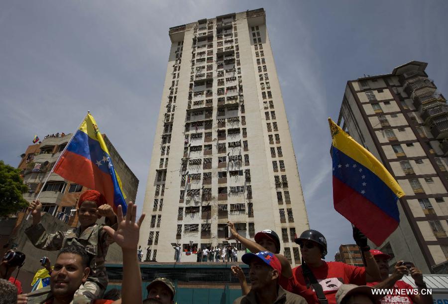 Residents participate in the funeral procession in honor of Venezuelan President Hugo Chavez on the streets of Caracas, capital of Venezuela, on March 6, 2013. On Tuesday afternoon, Venezuelan President, Hugo Chavez, died after fighting for almost two years with a cancer disease. The body of Chavez is moved from the health center to the Military Academy in southern Caracas, inside Tiuna's Fort. (Xinhua/David de la Paz)