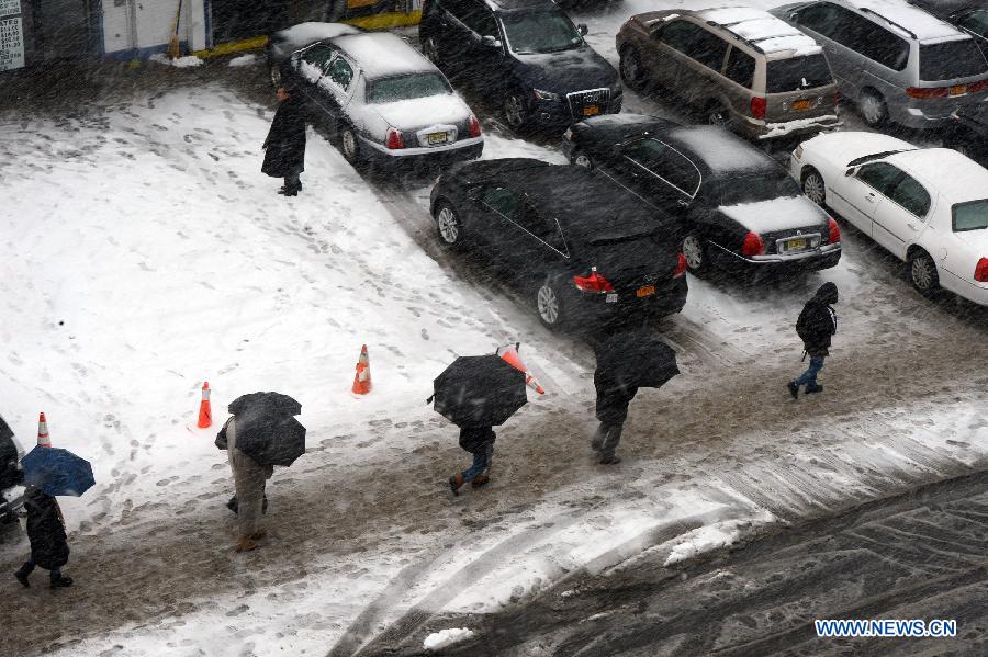 Pedestrians walk amid snow at Queens borough in New York, the United States, March 8, 2013. A late winter snowstorm hit New York on Wednesday. (Xinhua/Wang Lei) 