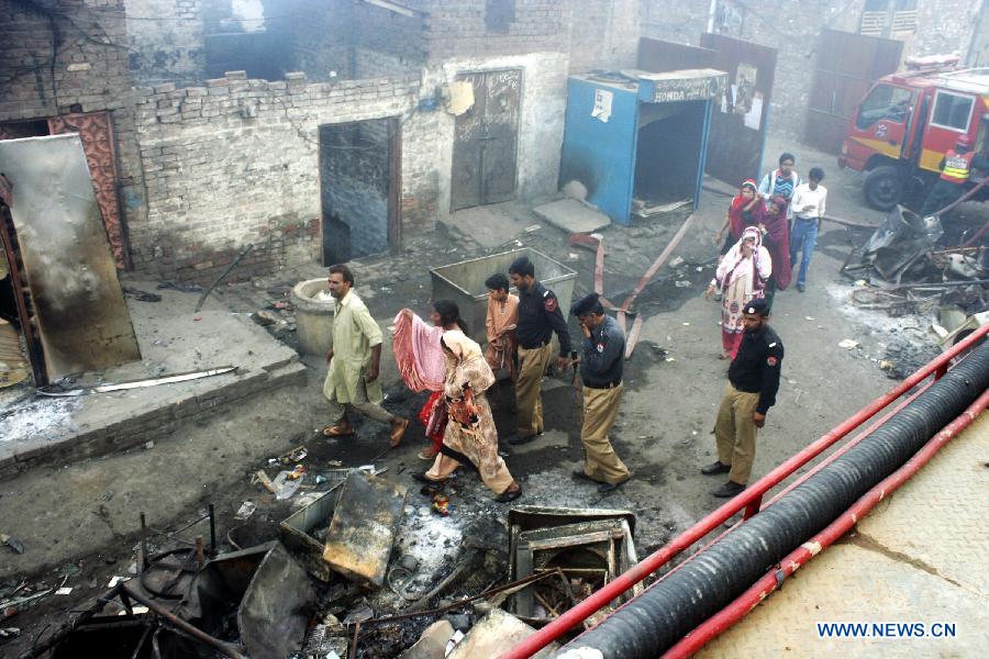 Pakistani Christians visit the burnt out houses after attacked by demonstrators during a protest in a Christian neighborhood in Badami Bagh area of eastern Pakistan's Lahore on March 9, 2013. Angry mob torched over 100 houses and shops of minority Christians in Badami Bagh area on Saturday after a Christian boy was accused of blasphemy, police and residents said. (Xinhua/Jamil Ahmed) 