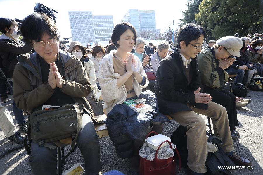 People attend a mourning ceremony in Tokyo, capital of Japan, on March 11, 2013. A mourning ceremony was held here Monday to mark the two year anniversary of the March 11 earthquke and ensuing tsunami that left more than 19,000 people dead or missing and triggered a nuclear accident the world had never seen since 1986. (Xinhua/Kenichiro Seki) 