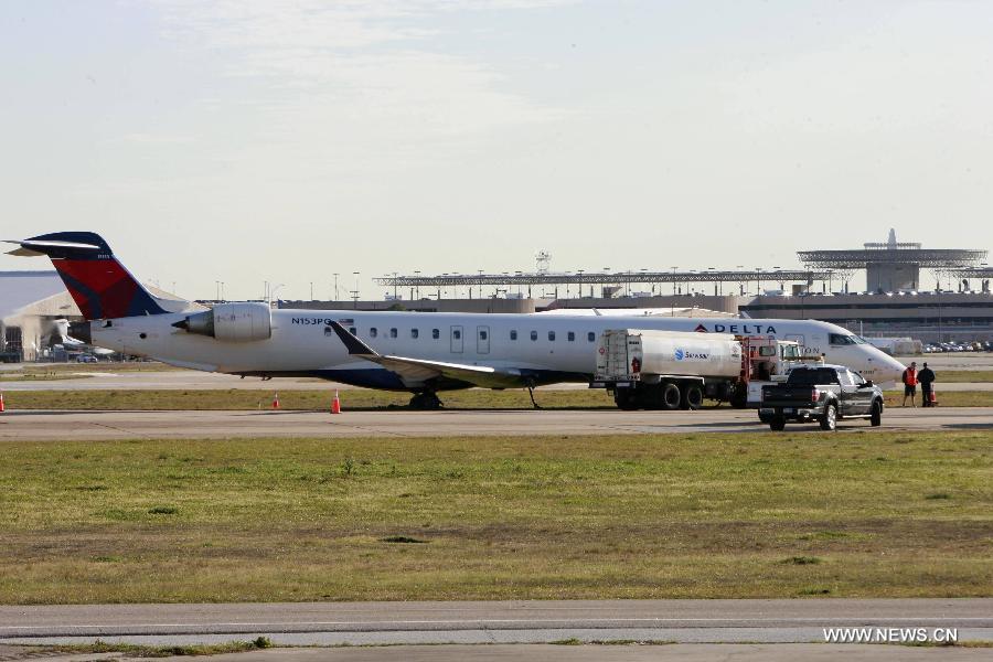 The Delta plane which ran off tha runway is seen at the Hobby Airport in Huston , the United States, March 11, 2013. A passenger plane of U.S. carrier Delta ran off the runway at Hobby Airport in the U.S. city of Houston on Monday, and no injuries were reported in the incident, officials said. (Xinhua/Song Qiong) 