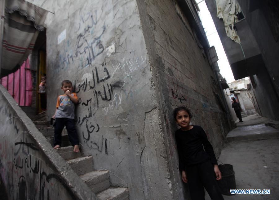 Palestinian kids play in the al-Shati refugee camp in Gaza City on March 13, 2013. About 700,000 Palestinians left their homes and settled in refugee camps in the Gaza Strip, the West Bank and neighboring Arab countries. (Xinhua/Yasser Qudih) 