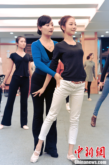 Trainer advises contestants how to build up good physique and deportment in Guangdong, March 19, 2013. More than 30 contestants who participate in the final round of the 2013 Miss Tourism International gather in Xijiao, China’s Guangdong province to attend a week-long training camp for better performance in competition. (CNS/ Long Yuyang)