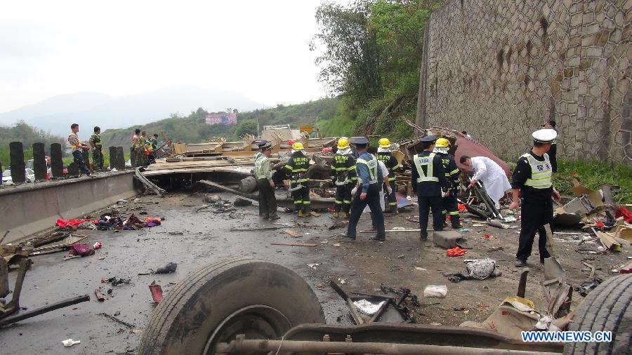 Rescuers works at the road accident site on the expressway from Zhangzhou to Longyan in Nanjing County, Zhangzhou, east China's Fujian Province. Eight people were killed and another 15 injured in the accident Friday. (Xinhua)