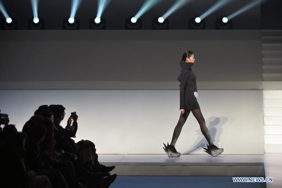 A model presents a creation of designers attending the 21st China International Young Fashion Designers Contest in Beijing, capital of China, March 25, 2013. The contest theming Boundary has attracted 29 designers from 16 countries. (Xinhua/Li Xin)