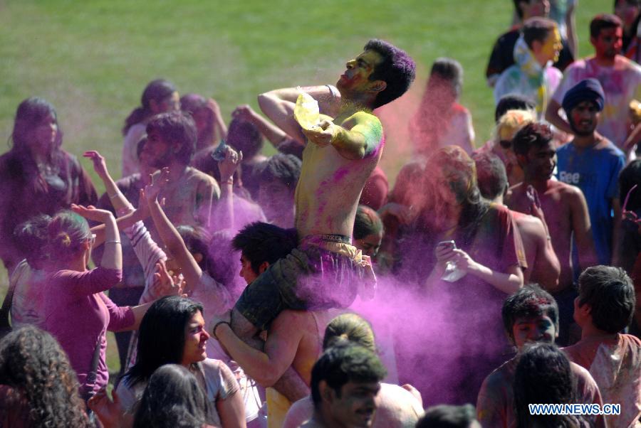 Students of University of British Columbia sing and throw coloured powder on each other as they celebrate Holi, the Indian Festival of Colors, in Vancouver, Canada, on March 30, 2013. Holi is all about celebrating the colors and vitality of spring, with family and friends. (Xinhua/Sergei Bachlakov) 