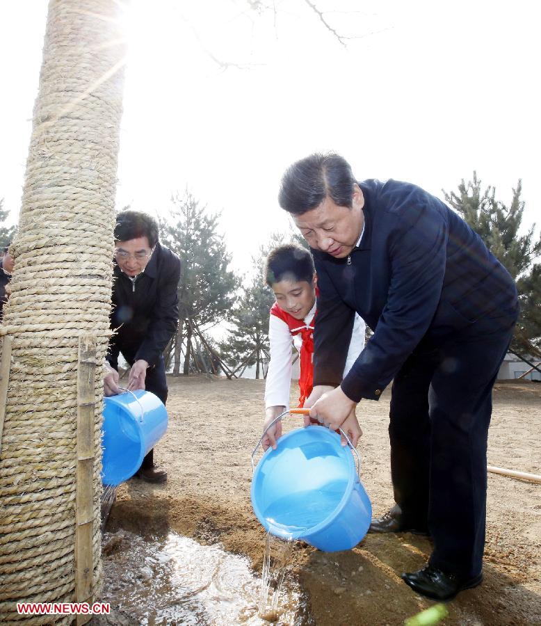 Xi Jinping (front) waters a maidenhair tree together with a pupil during a tree-planting event in Fengtai District in Beijing, capital of China, April 2, 2013. Chinese top leaders Xi Jinping, Li Keqiang, Zhang Dejiang, Yu Zhengsheng, Liu Yunshan, Wang Qishan and Zhang Gaoli joined in the tree planting event here on Tuesday. (Xinhua/Ju Peng)