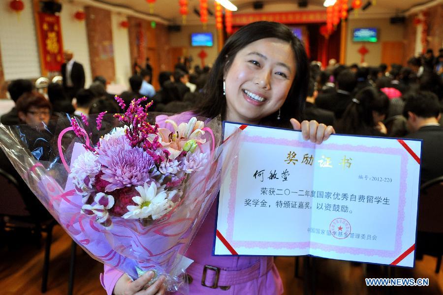 Doctor He Minxuan from the University of California at Berkeley shows her certificate after the awarding ceremony of Chinese Government Award for Outstanding Self-financed Students Overseas at the consulate general of the People's Republic of China at San Francisco, April 5, 2013. All together 20 students from the University of California at Berkeley, Stanford University, Washington University, University of California at Davis and Washington State University won the scholarship. (Xinhua/Liu Yilin)