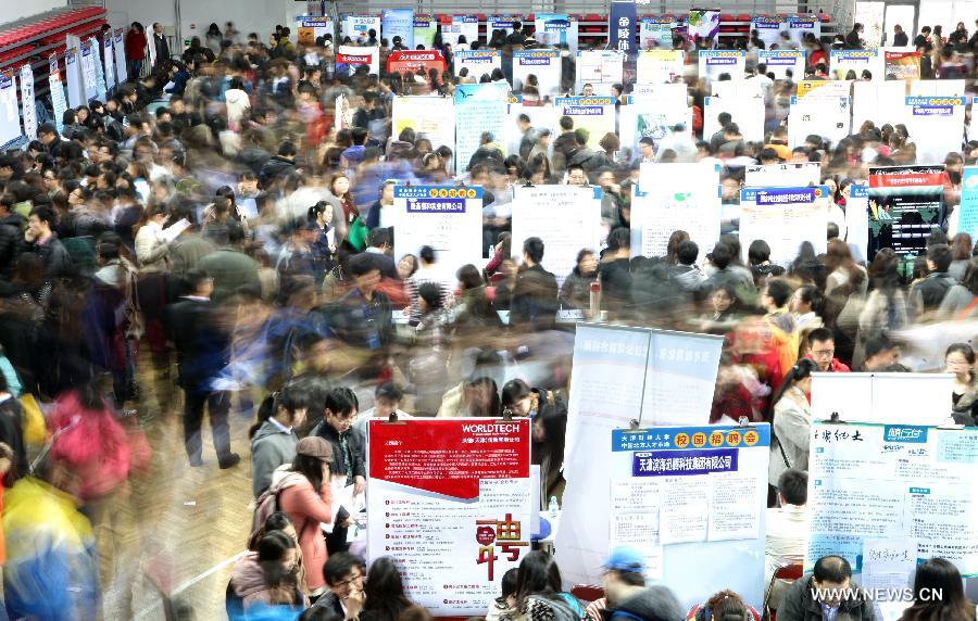 Job hunters inquire information at a job fair at the Tianjin University of Finance and Economics in Tianjin, north China, April 10, 2013. The job fair attracted 225 enterprises and institutions, providing 4,700 job vacancies for college graduates. (Xinhua/Liu Dongyue)  