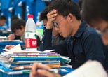 High school students prepare for exam in temporary tent  