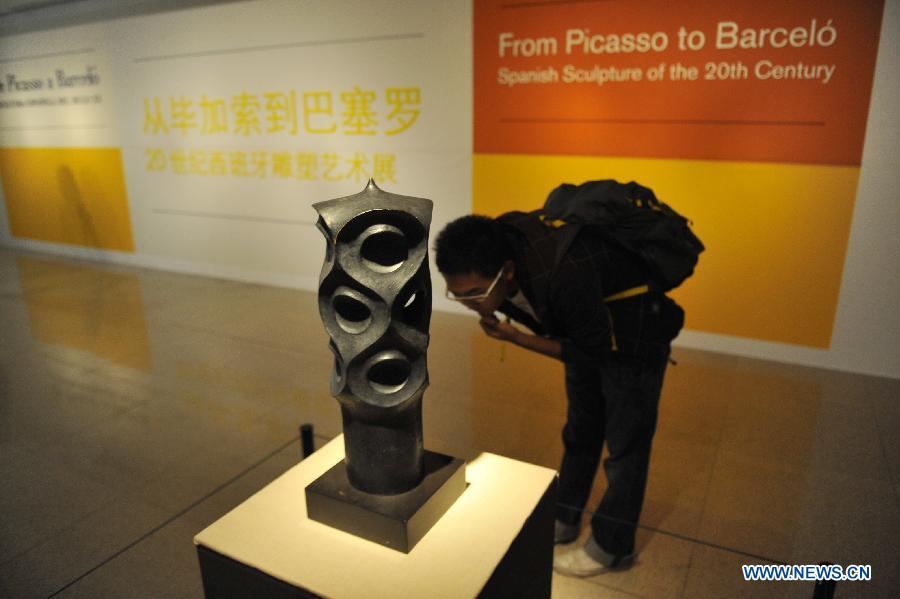 A visitor looks at an artwork from Spanish architect Gaudi in an exhibition of "From Picasso to Barcelo - Spanish Sculpture of the 20th Century" in Beijing, capital of China, April 22, 2013. A total of 79 pieces of artworks of famous Spanish artists were presented in the exhibition which celebrated the 40th anniversary of the establishment of diplomatic ties between China and Spain. (Xinhua/Lu Peng)