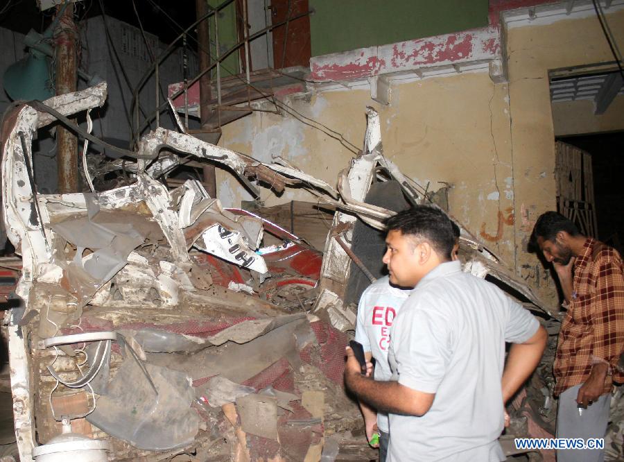 People examine the blast site in southern Pakistani port city of Karachi on April 26, 2013. At least 11 people including a child were killed and 40 others injured on Friday night in a bomb blast that targeted a political meeting in Pakistan's southern port city of Karachi, local media and police said. (Xinhua/Masroor)