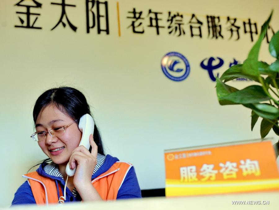 A staff member answers a phone call at a 24-hour assistance center for senior citizens in Fuzhou, capital of southeast China's Fujian Province, April 28, 2013. A total of 435 community service centers have been set up in Fuzhou since 2008 to provide daily care and entertainment activities for senior citizens. (Xinhua/Zhang Guojun)