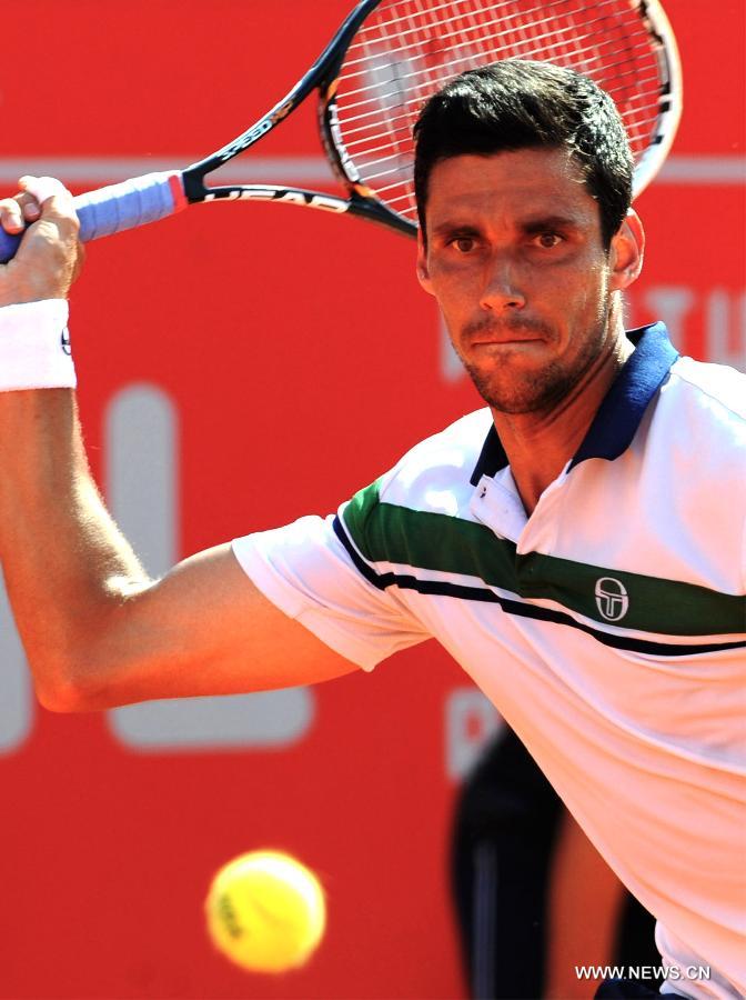 Romania's Victor Hanescu returns a shot during the men's singles quarterfinal against Spain's David Ferrer during the 2013 Portugal Open in Lisbon, Portugal, May 3, 2013. Ferrer won the match 2-0. (Xinhua/Zhang Liyun) 