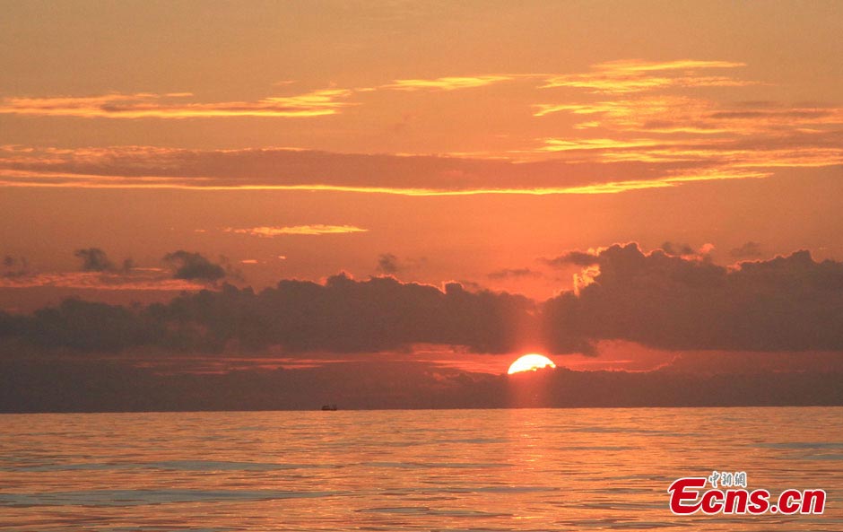 The sky turns red at sunset over waters off the Nansha Islands in the South China Sea, May 14, 2013. A fleet of 32 Chinese fishing boats arrived in Nansha Islands on Tuesday after a 7-day voyage. (CNS/Wang Xiaobin)