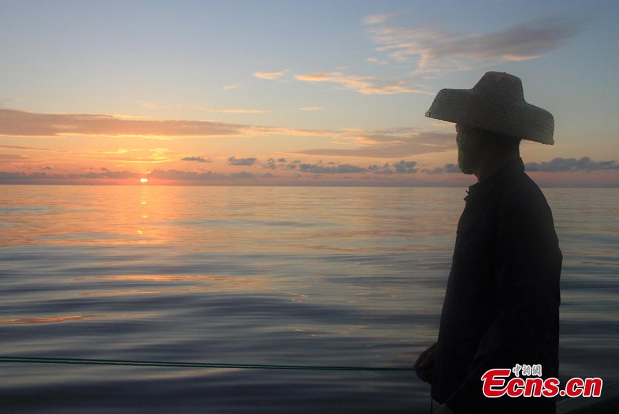 The sky turns red at sunset over waters off the Nansha Islands in the South China Sea, May 14, 2013. A fleet of 32 Chinese fishing boats arrived in Nansha Islands on Tuesday after a 7-day voyage. (CNS/Wang Xiaobin)