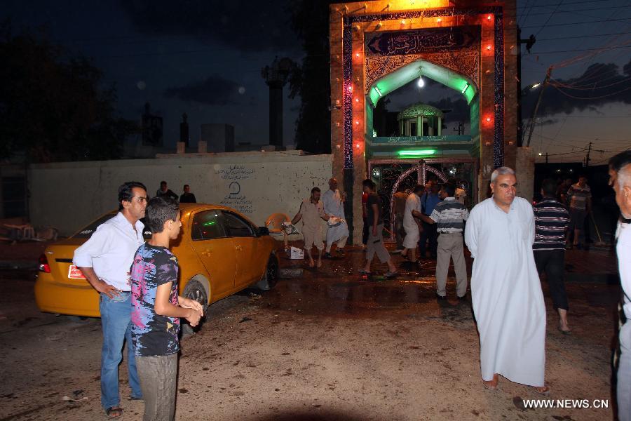 People clean the blast site at a Shiite mosque in Kirkuk, northern Iraq, May 16, 2013. At least 12 people were killed and 25 others injured as a suicide bomber blew himself up at a Shiite mosque in northern Iraq's Kirkuk on Thursday, local police sources said. (Xinhua/Dena Assad)