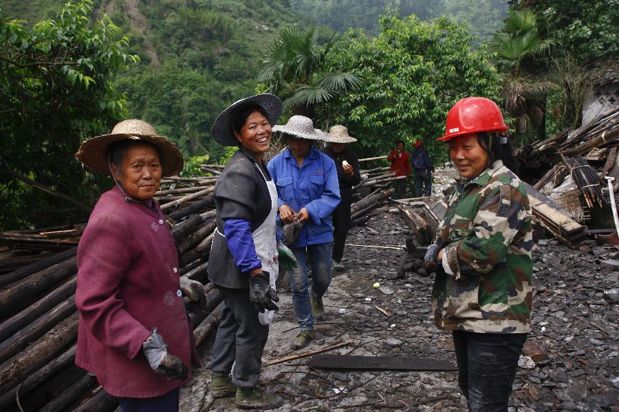 Villagers enjoy a break during house reconstruction in Xiangshuixi Village in Tianquan County, southwest China's Sichuan Province, May 18, 2013. Villagers who were affected by the earthquake that jolted the region on April 20 are rebuilding their houses with building materials recovered from the ruins. (Xinhua/Cui Xinyu) 