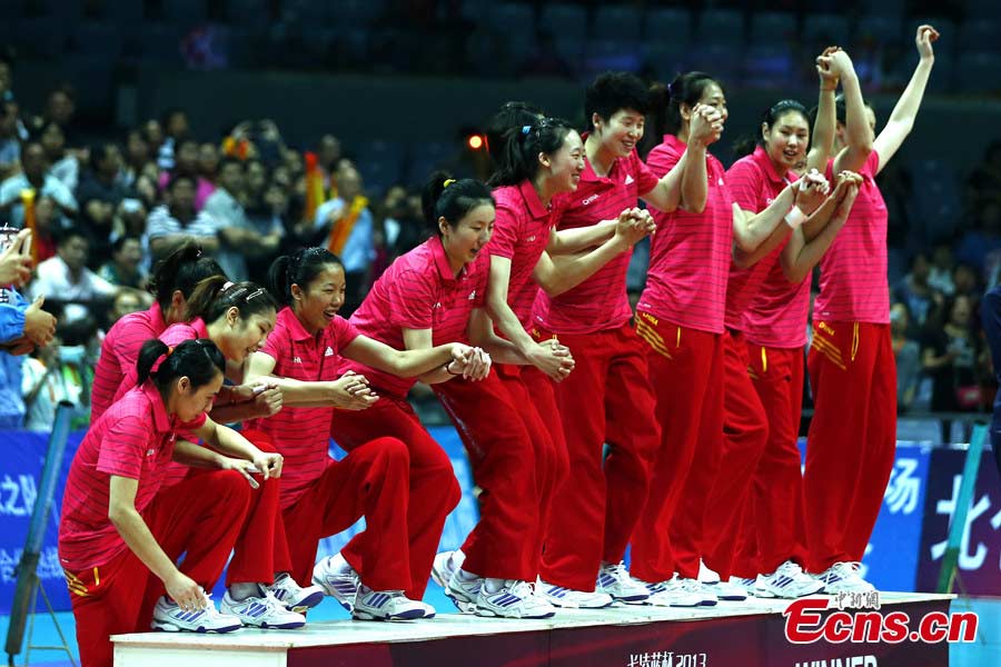 The Chinese women's volleyball team celebrates their victory after beating Puerto Rico in straight sets in Ningbo, Zhejiang Province, May 19, 2013. The Chinese team, which was formed last week, proved a class above their opponents and won the match 25-12, 25-20, 25-14 in just one hour and 11 minutes at the Beilun International Volleyball Tournament.(CNS/Fu Tian)