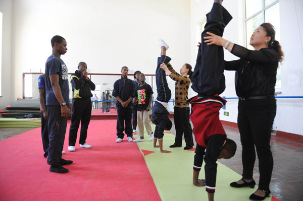 Students from Nigeria practice acrobatics in Wuqiao county, North China's Hebei province, May 20, 2013. Eight Nigerian students, 14 to 18 years old, began a one-year training course at a local acrobat school, where more than 300 African students have been studying since 2002. Wuqiao county is known as the "home of acrobatics" with more than 1,500 acrobats and 60 troupes. [Photo/Xinhua]