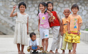 Migrant children pose for photo shooting