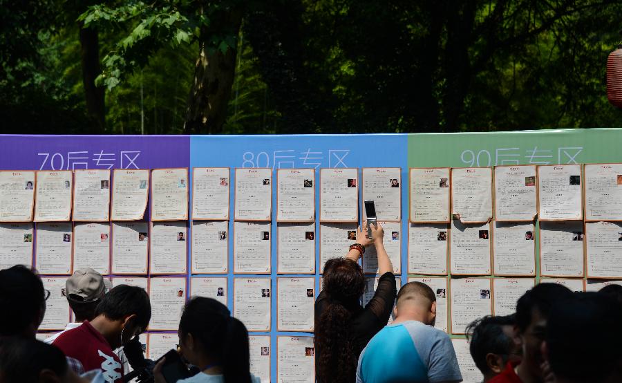 People take part in a blind date event at Huanglongdong scenic area in Hangzhou, capital of east China's Zhejiang Province, May 25, 2013. The event attracted over 5,000 participants, including both young singles and their parents. (Xinhua/Xu Yu)