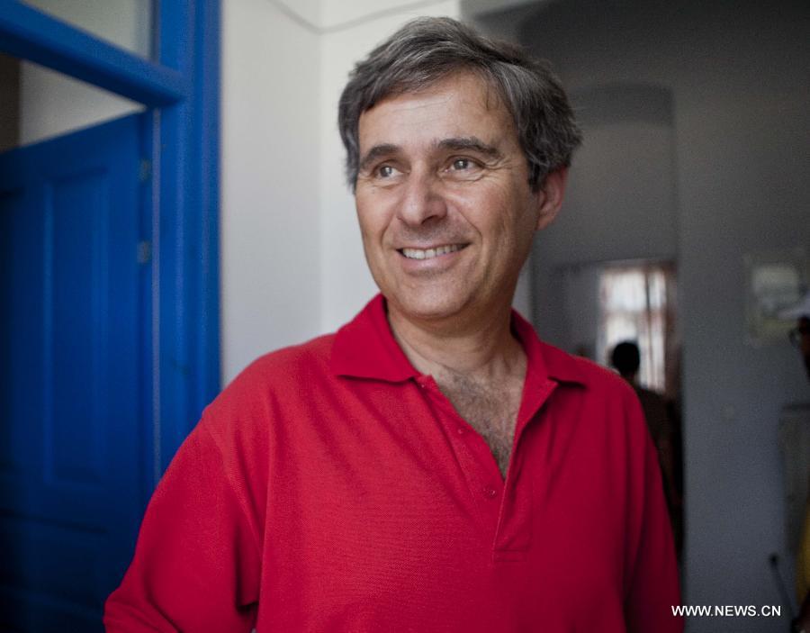 Yiannis Gavalas, a principal of the only school in Iraklia island, Greece, stands in school on May 22, 2013. For over 20 years, Gavalas has been working in this tiny island covers an area of 18 square kilometers with more than 100 residents. He has recorded about 650 species of plants, 174 species of birds and 26 species of butterflies in his spare time. He has published a book about local butterflies and more will follow. (Xinhua/Liu Yongqiu)