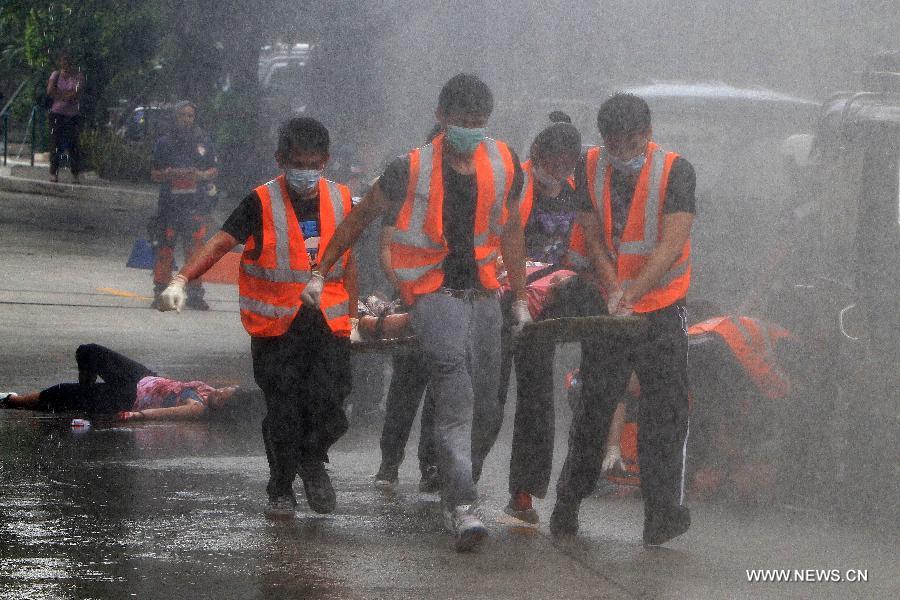 Rescuers carry a mock victim during a rescue drill in Quezon City, the Philippines, May 31, 2013. (Xinhua/Rouelle Umali) 