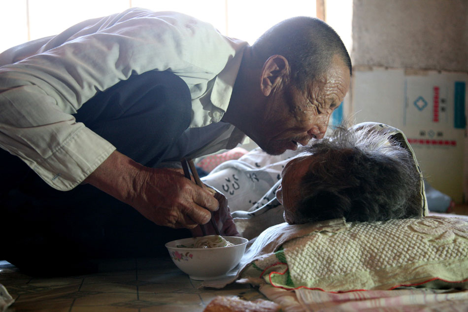 Wang He feeds her mother on May 5, 2013. 