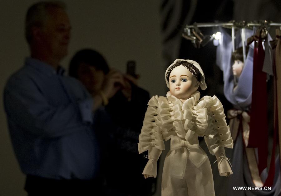 A dressed-up doll is seen at the Viktor & Rolf Dolls exhibit, as part of the 2013 Luminato Festival, at Royal Ontario Museum in Toronto, Canada, June 14, 2013. Every aspect of each doll's look was scaled down to create exact replicas of the original creation by designers Viktor Horsting and Rolf Snoeren. (Xinhua/Zou Zheng)