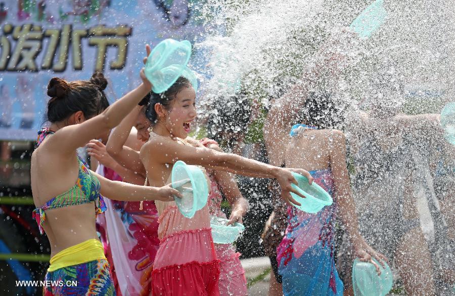 People attend a water-splashing festival during the summer at the Colorful World in Changsha, capital of central China's Hunan Province, June 29, 2013. (Xinhua/Li Ga) 