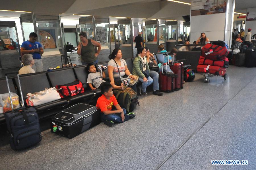 Passengers wait at San Francisco International Airport, the United States, July 6, 2013. The South Korean consulate has confirmed that the pair killed in a crash landing of an Asiana Airlines plane at San Francisco airport were women holding Chinese passports, the Chinese Consulate General in San Francisco told Xinhua Sunday. (Xinhua/Liu Yilin)