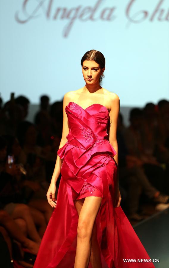 A model presents a creation of a brand at the 20th Hong Kong Fashion Week for Spring/Summer in south China's Hong Kong, July 10, 2013. The four-day fair, which is organized by the Hong Kong Trade Development Council, kicked off at the Hong Kong Convention and Exhibition Center Monday. (Xinhua/Li Peng)